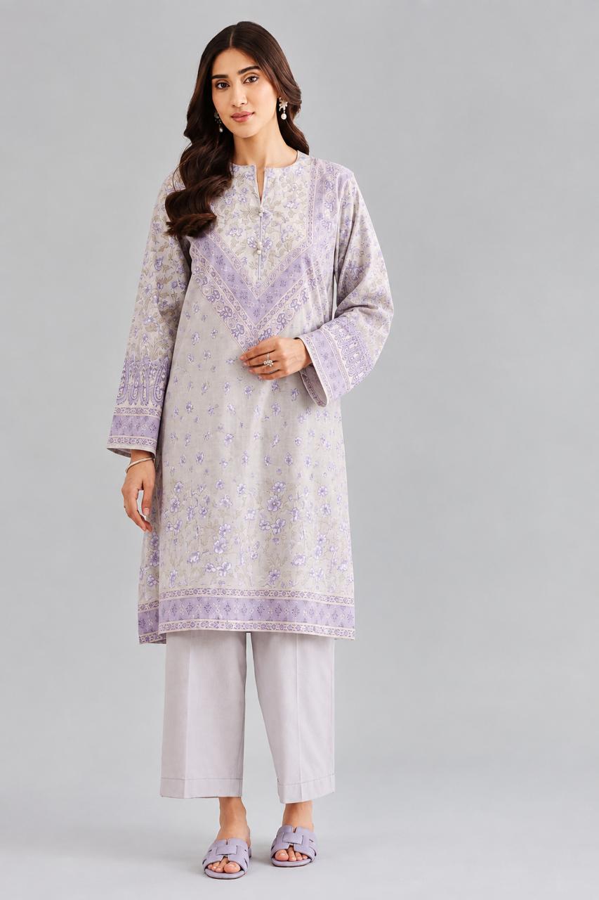 "Woman wearing a 2 piece digital printed suit with matching trousers in premium lawn fabric"
